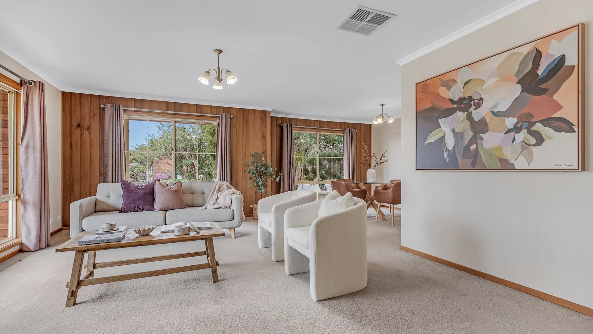 Dining setting with bentwood chairs and botanical prints on the wall at Edwards Court, Echuca