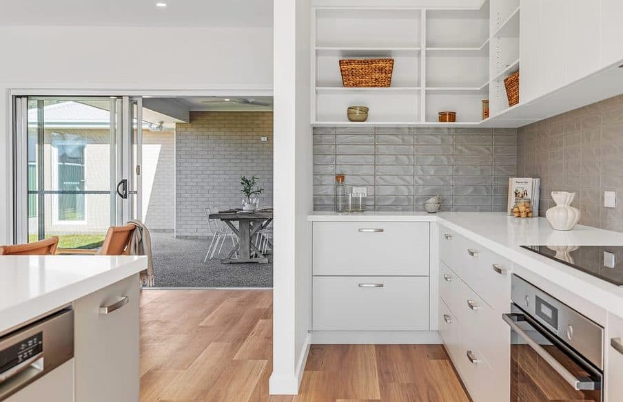 Kitchen styled for sale by Wisteria & Oak, with open shelving, a woven basket and a tiled splashback