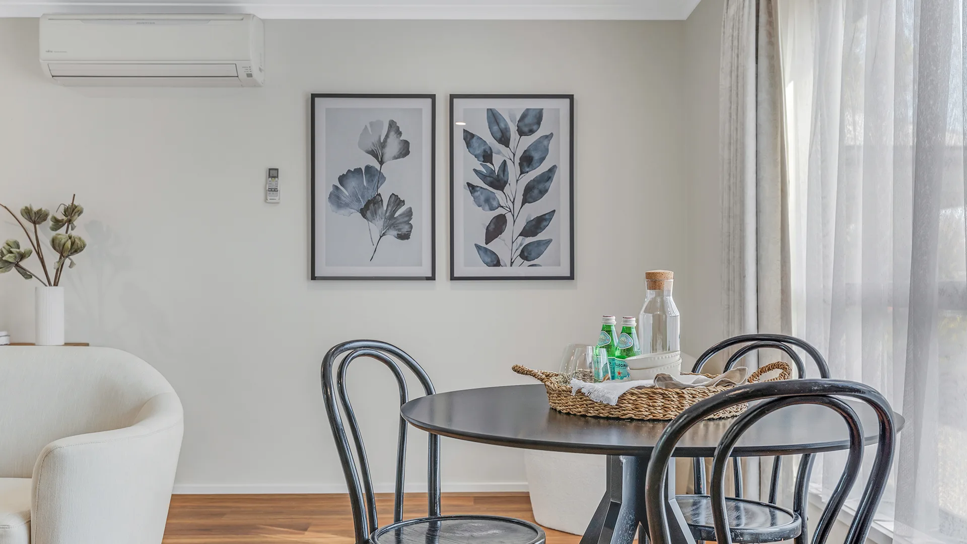 Dining setting with bentwood chairs and botanical prints above at Goulburn Road, Echuca