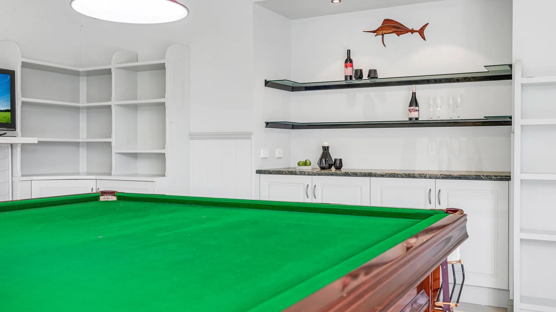 Billiard room with a full size table, open shelving and a wall mounted screen at Lignum Road, Moama